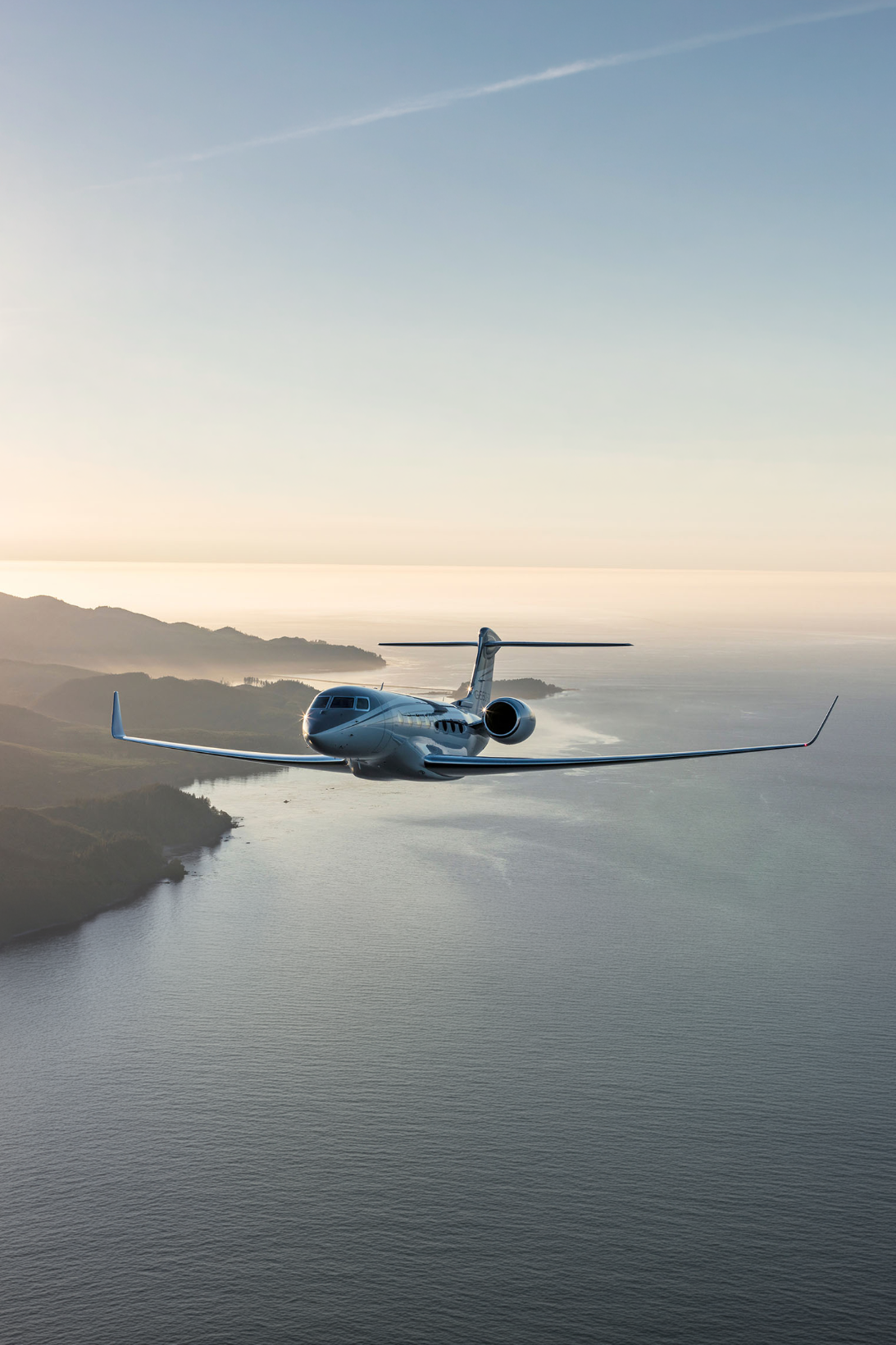 Private jet flying above the coast
